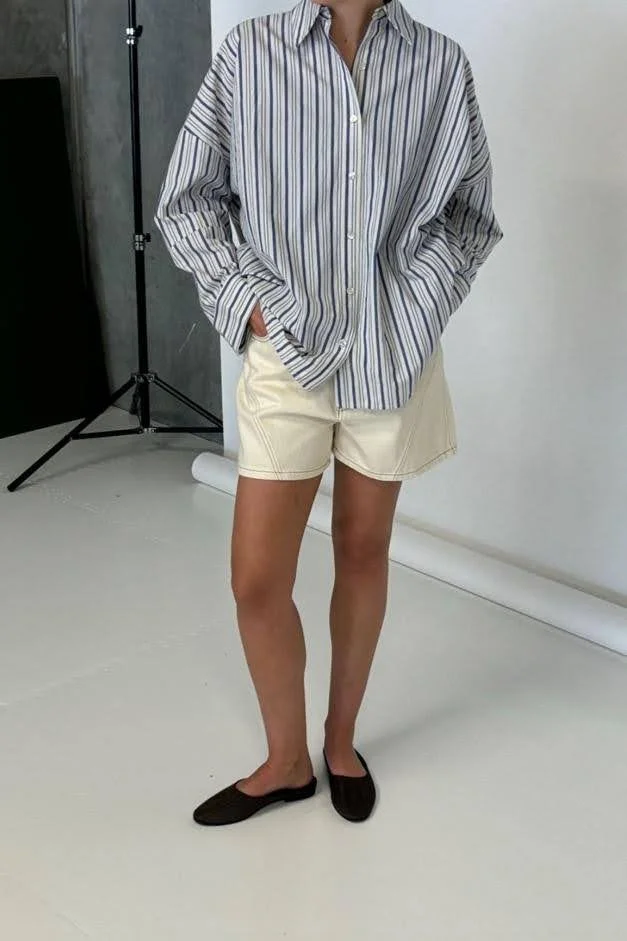 woman wearing striped white and blue button down shirt