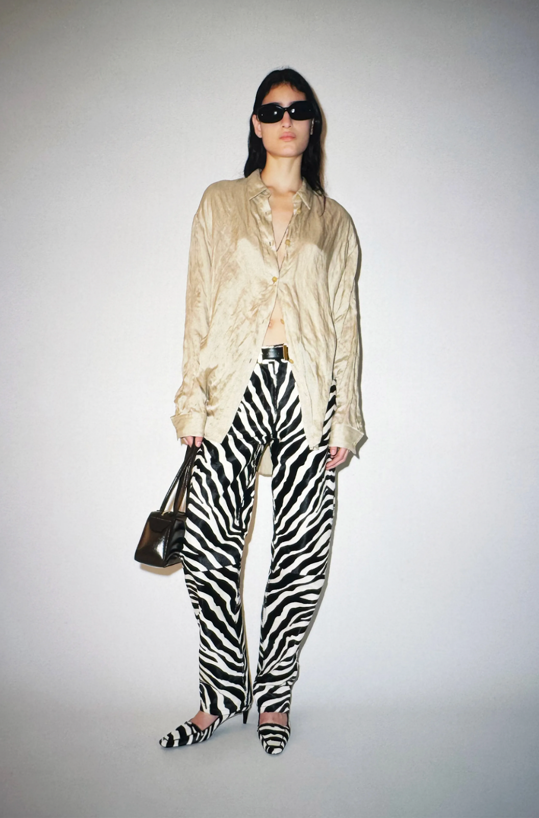 model wearing blouse and zebra pants