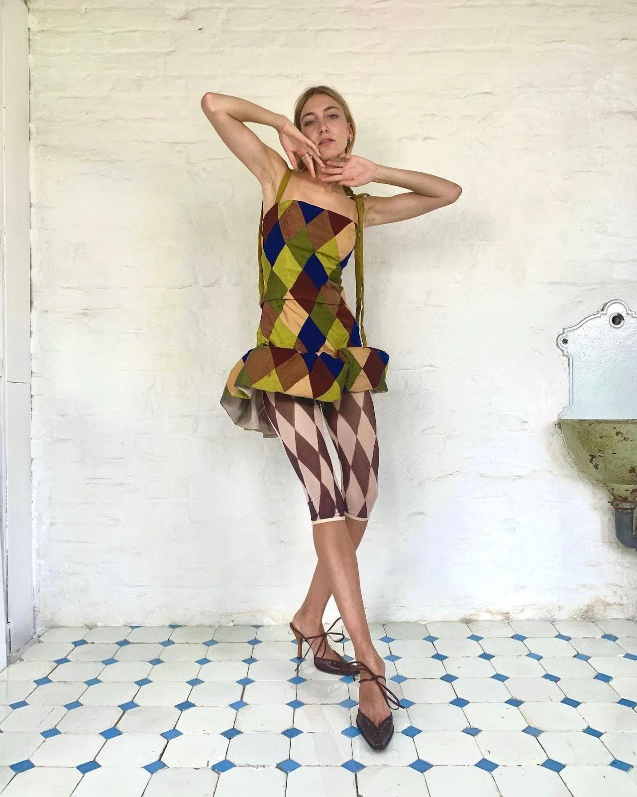 fashion model wearing diamond joker clown print inspired outfit