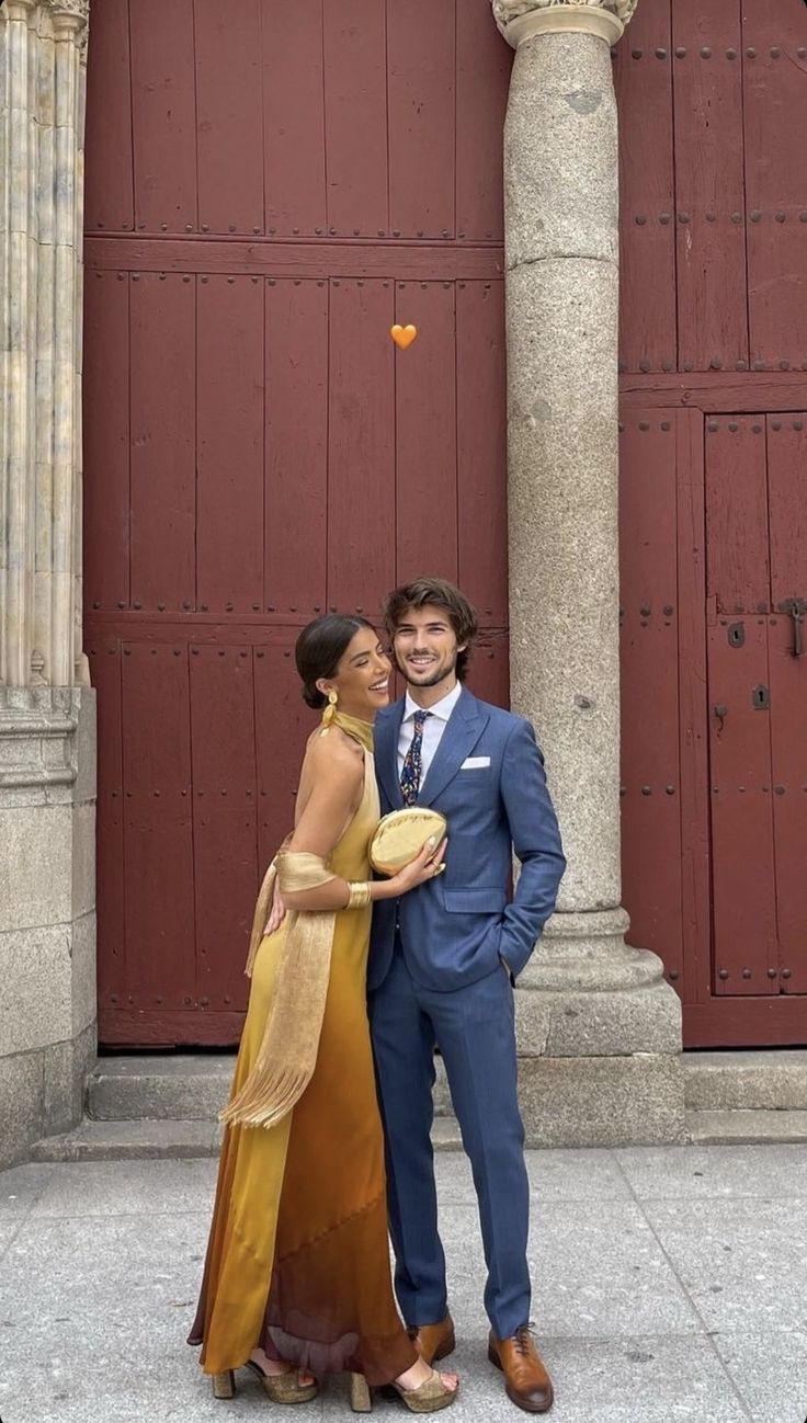 couple at formal wedding wearing gold satin dress and blue suit
