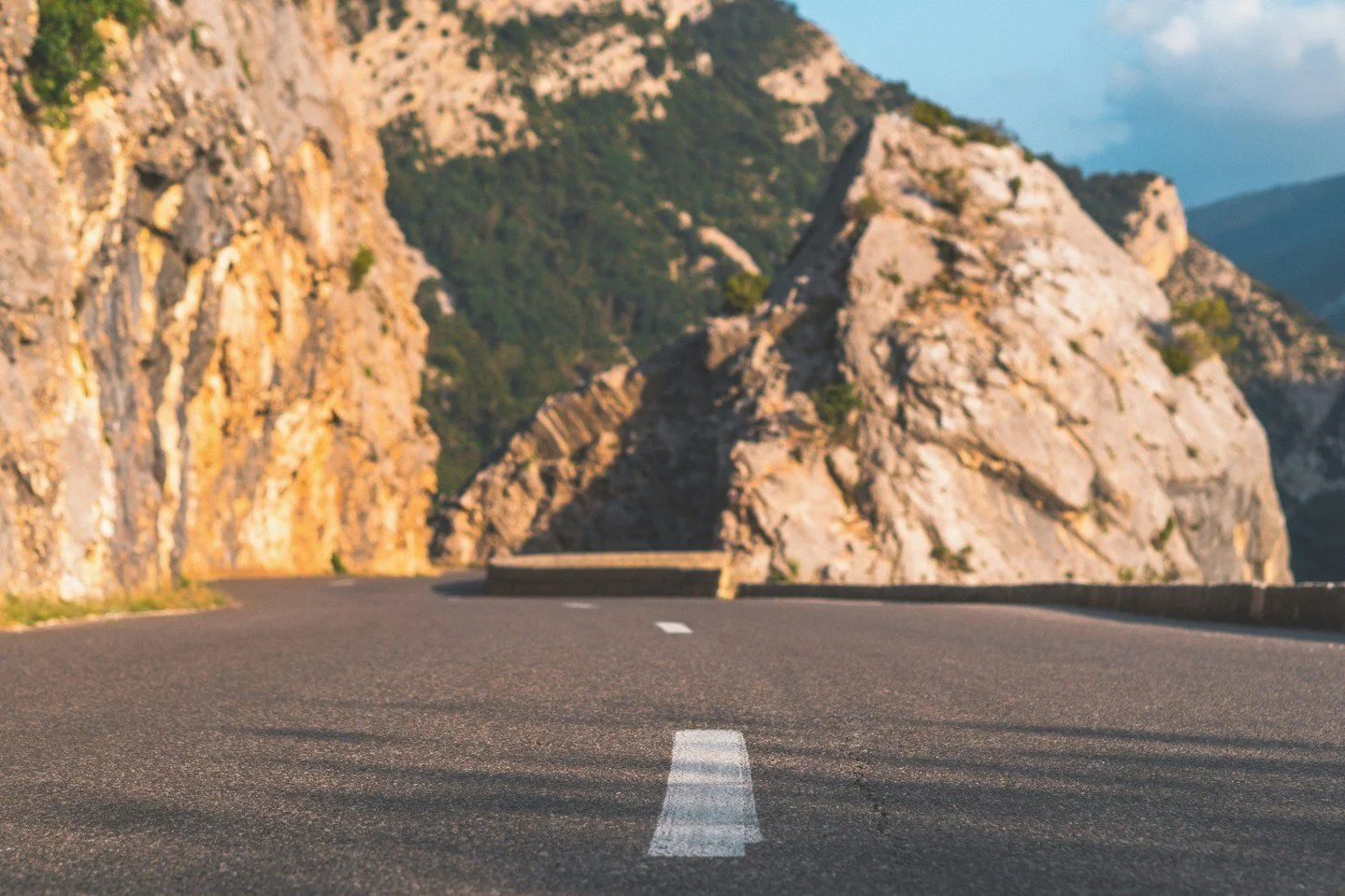 The winding road through the Gorges du Verdon - France's deepest canyon.⁠
⁠
Hugging the limestone wall of the gorge the road continues to rise with every turn (of which there are plenty). There are steep drops into the ravine below, with only occasio