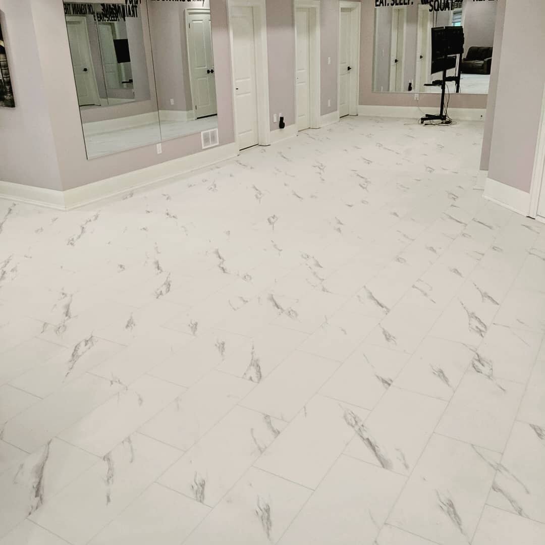 Marble luxury vinyl tile looks amazing in this basement #LVT #lvtflooring #flooring #floor #basement #bovaflooring