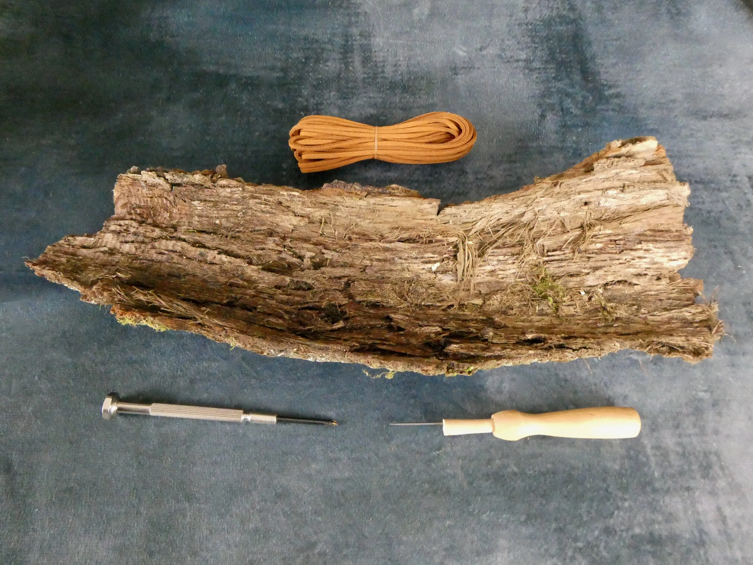 Example of a piece of bark, inner side upwards - where you will place your air plants etc. You can also see the implements I use to create holes in the bark and an example of hanging cord