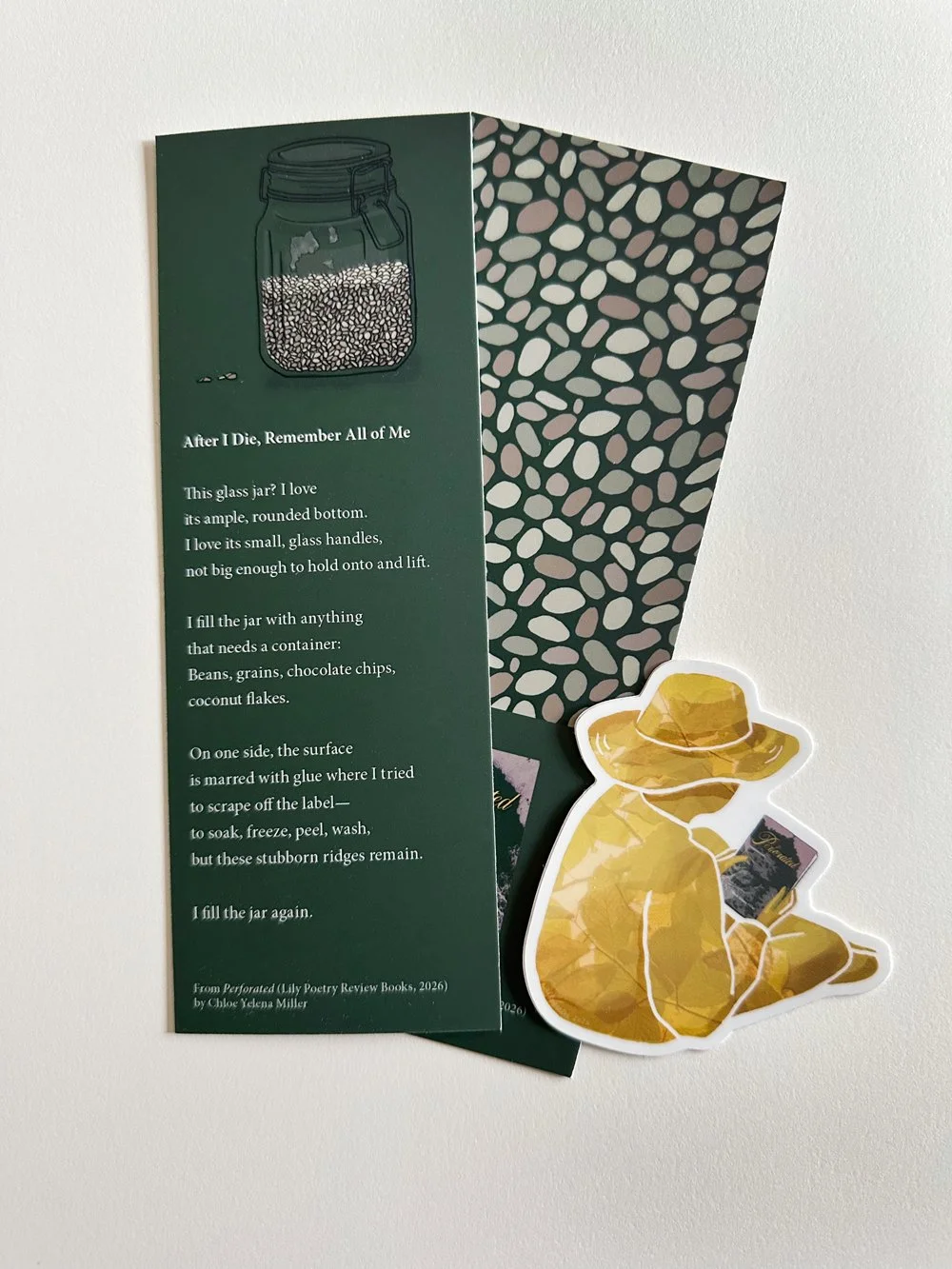 Photograph of printed promotional bookmark, front and back, and sticker