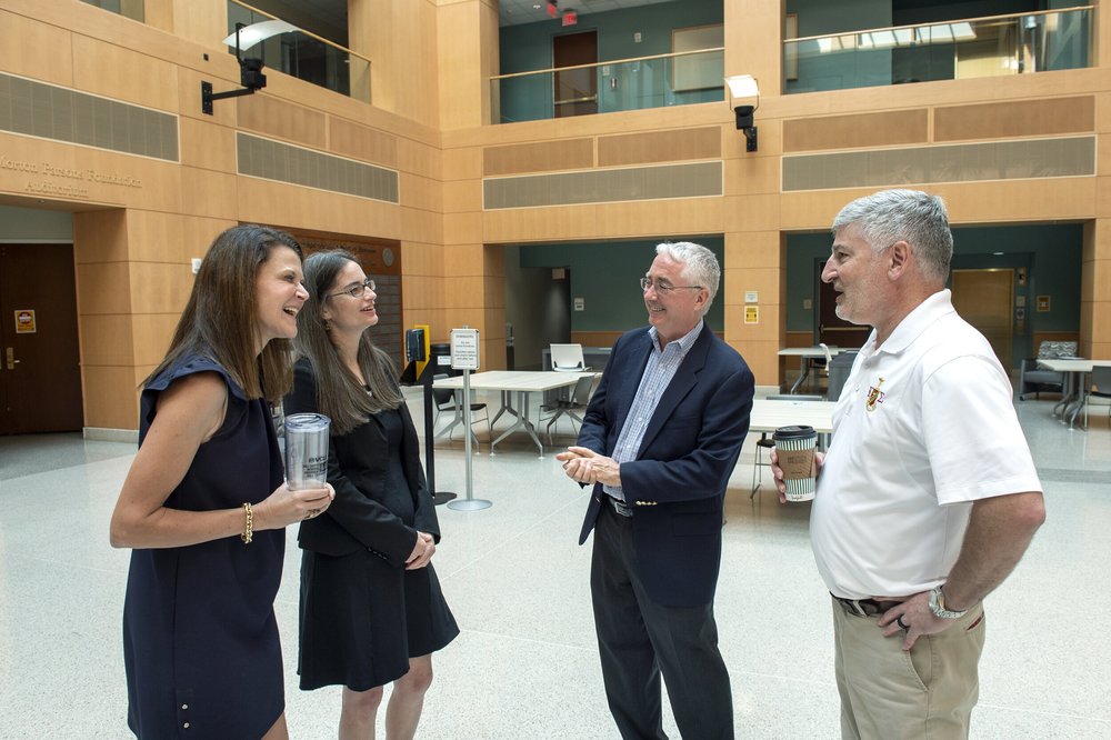   VCU’s Cheryl Slokker, Communications Director, and Katy Beisheim, Associate Director of Development (in glasses picture #2) accept a check to the Endowment on behalf of the VCU School of Business. Brad Welles and Craig Corrieri representing the End