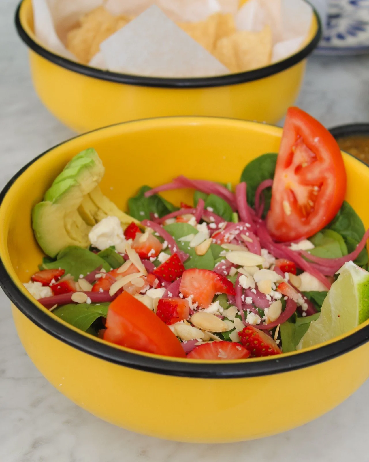 Lettuce celebrate a delicious meal with you! 🥳 Try our specialty salads like this espinacas with toasted almonds, strawberries, avocado, tomatoes, pickled onions, feta cheese, and a dijon mustard vinaigrette. 🥗😋