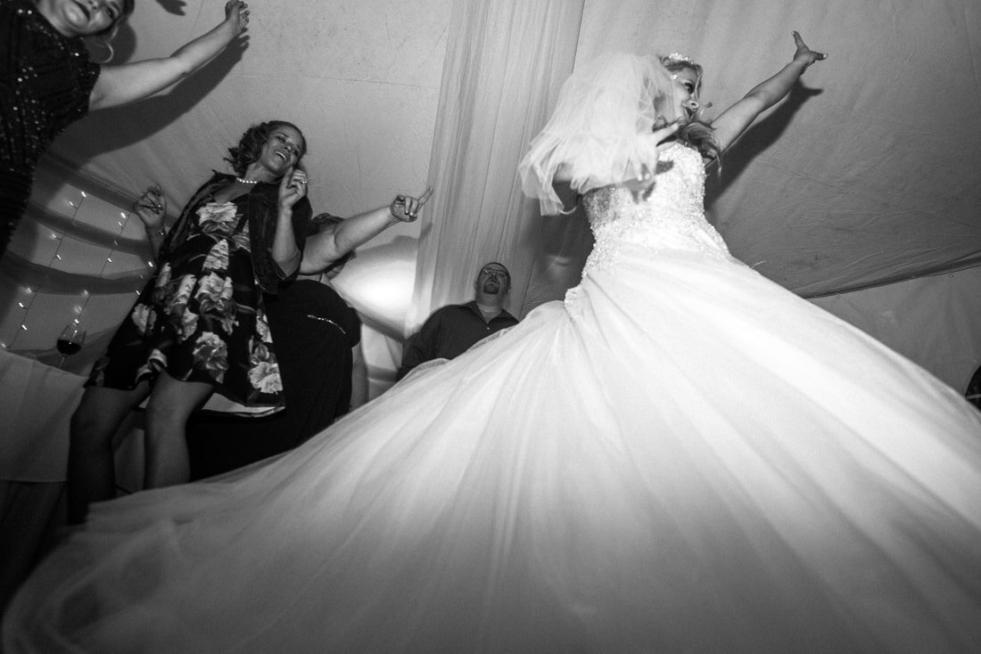 bride has a blast under the white tent at her Prince Edward County Wedding