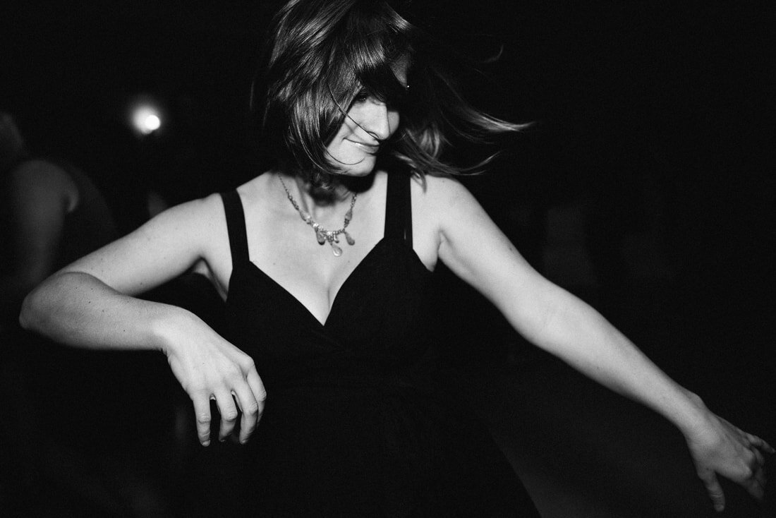 Black and white image of a woman dancing in her own world