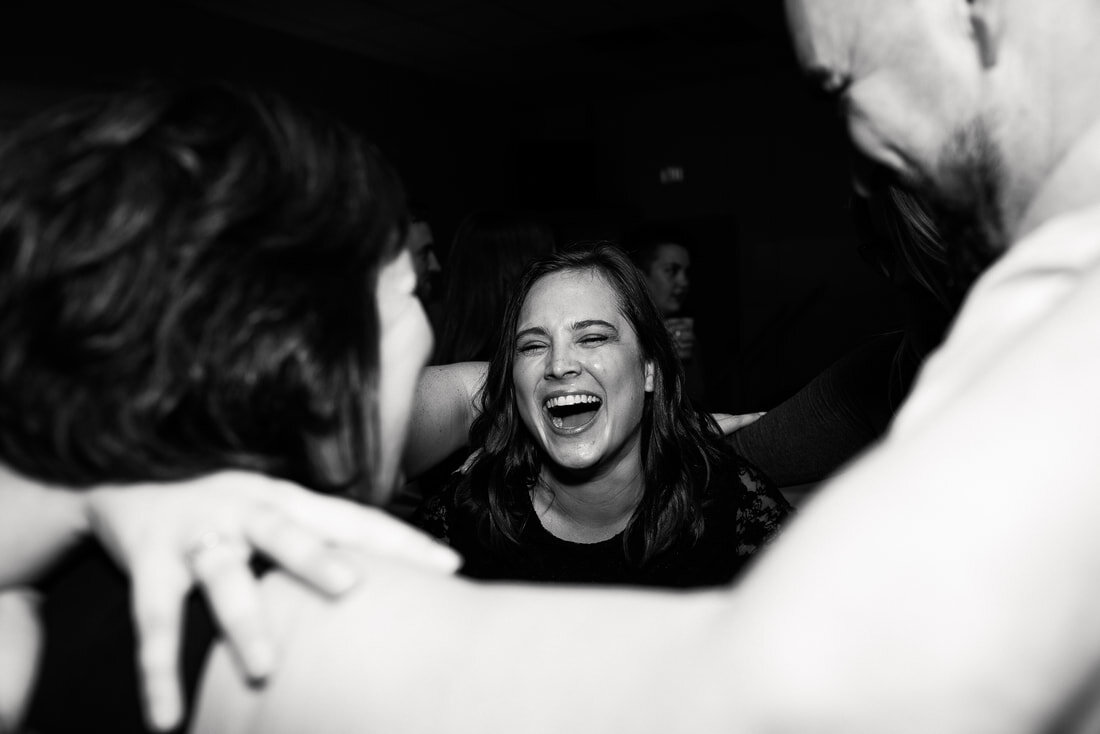 Black and white picture of friends jumping around together in the party