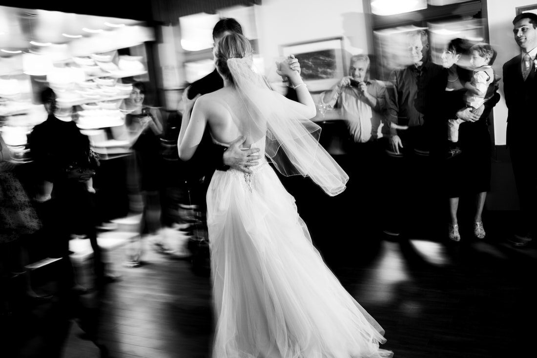 Black and white image of newly wedded couple dancing together