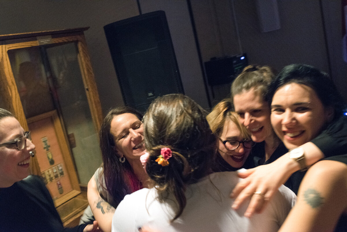 Bride and friends in group hug at Kingston, Ontario wedding 