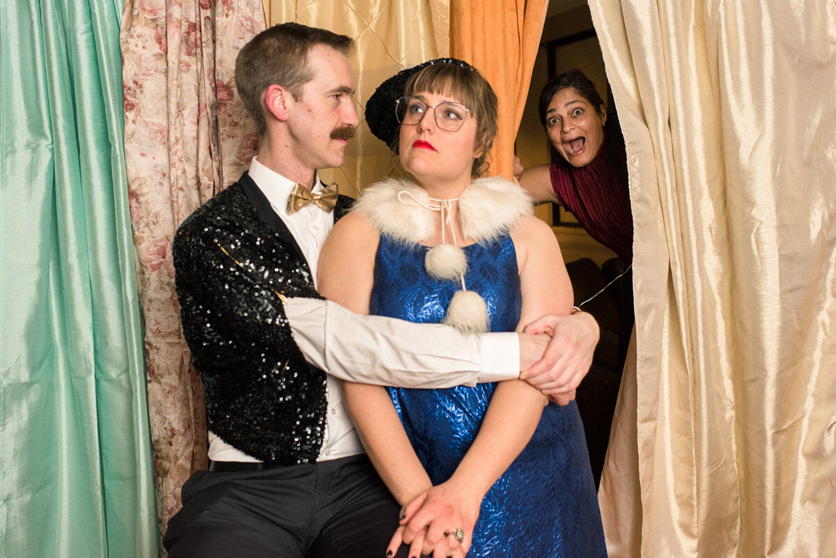 Guests laughing and posing in costumes at photo booth at Kingston, Ontario wedding