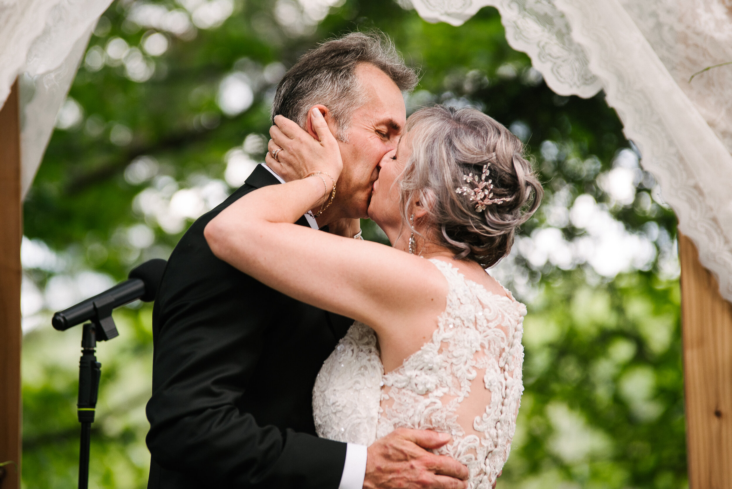 Bride and groom sharing their first married kiss at wedding in Verona, Ontario