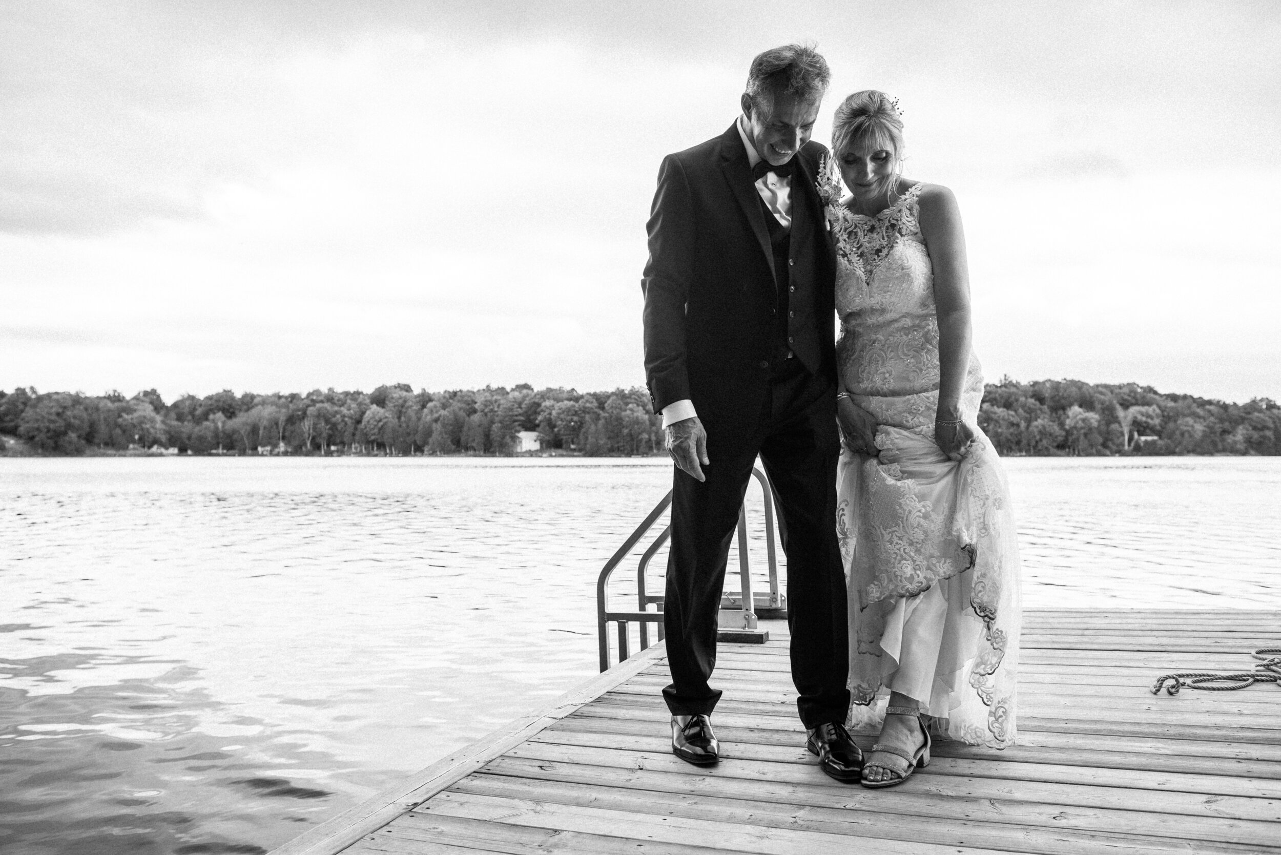 Bride and groom on dock on the lake at Verona, Ontario wedding 