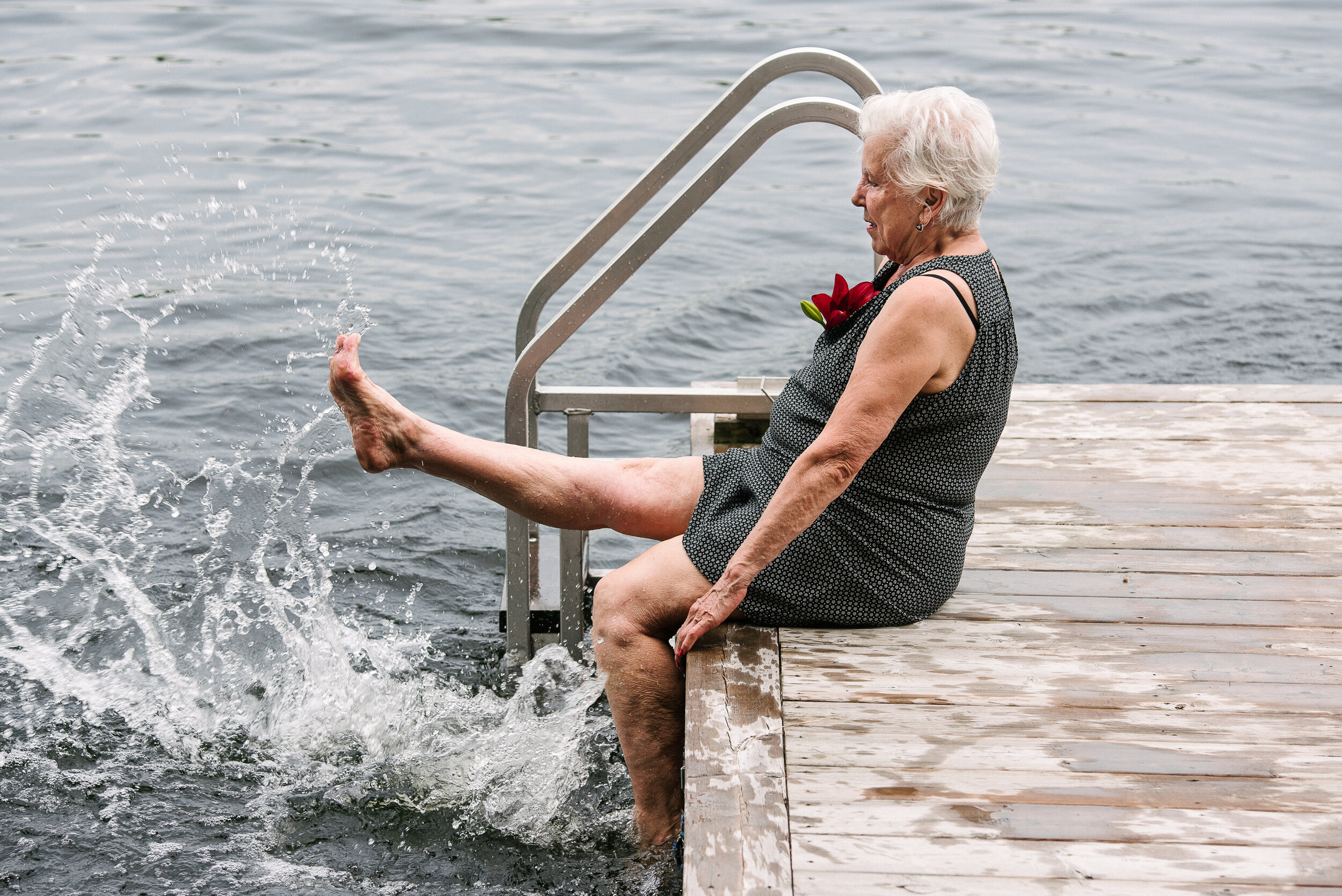 Older guest kicking and splashing her legs in the lake
