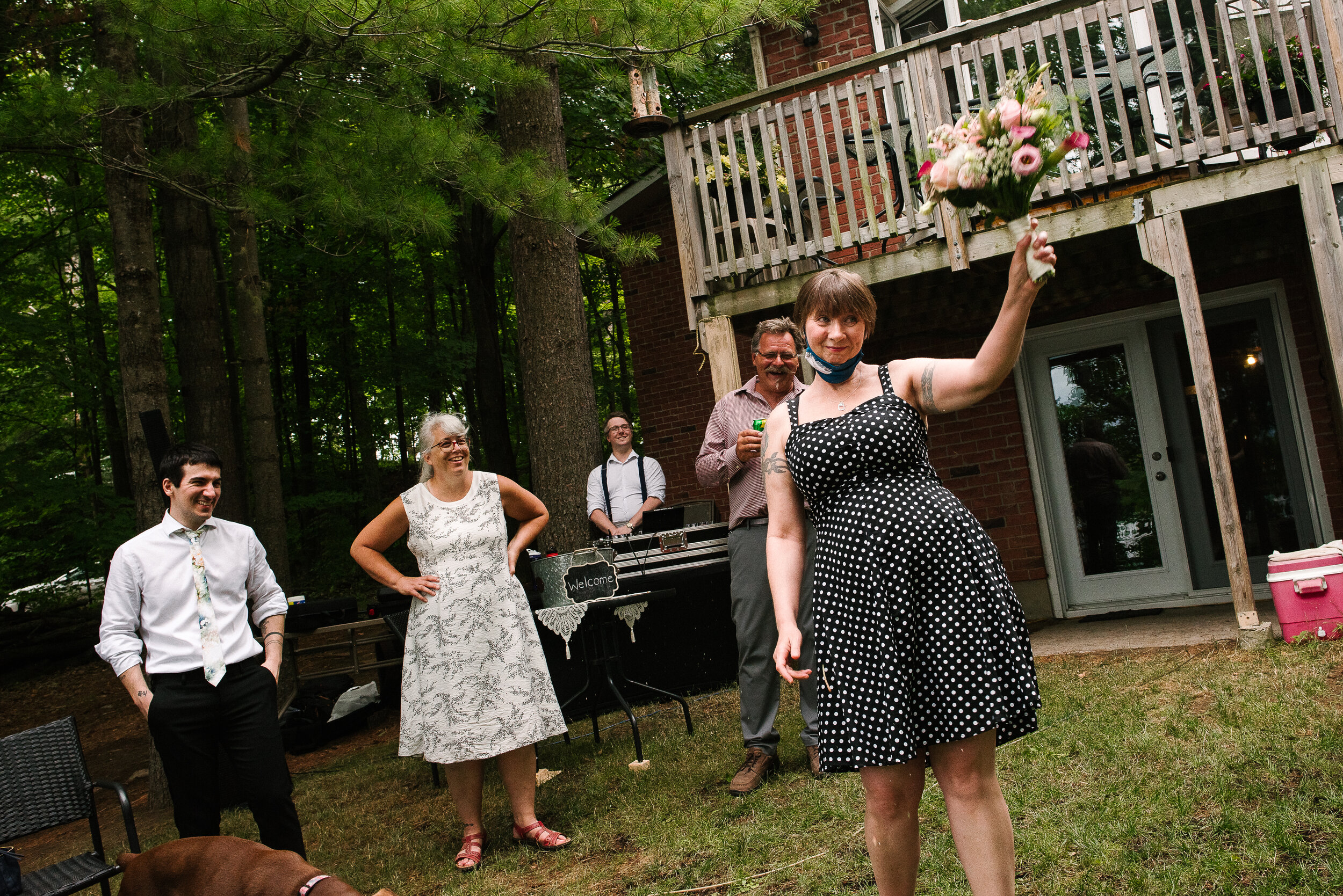 Guest showing the bouquet that she just caught at Verona, Ontario wedding 