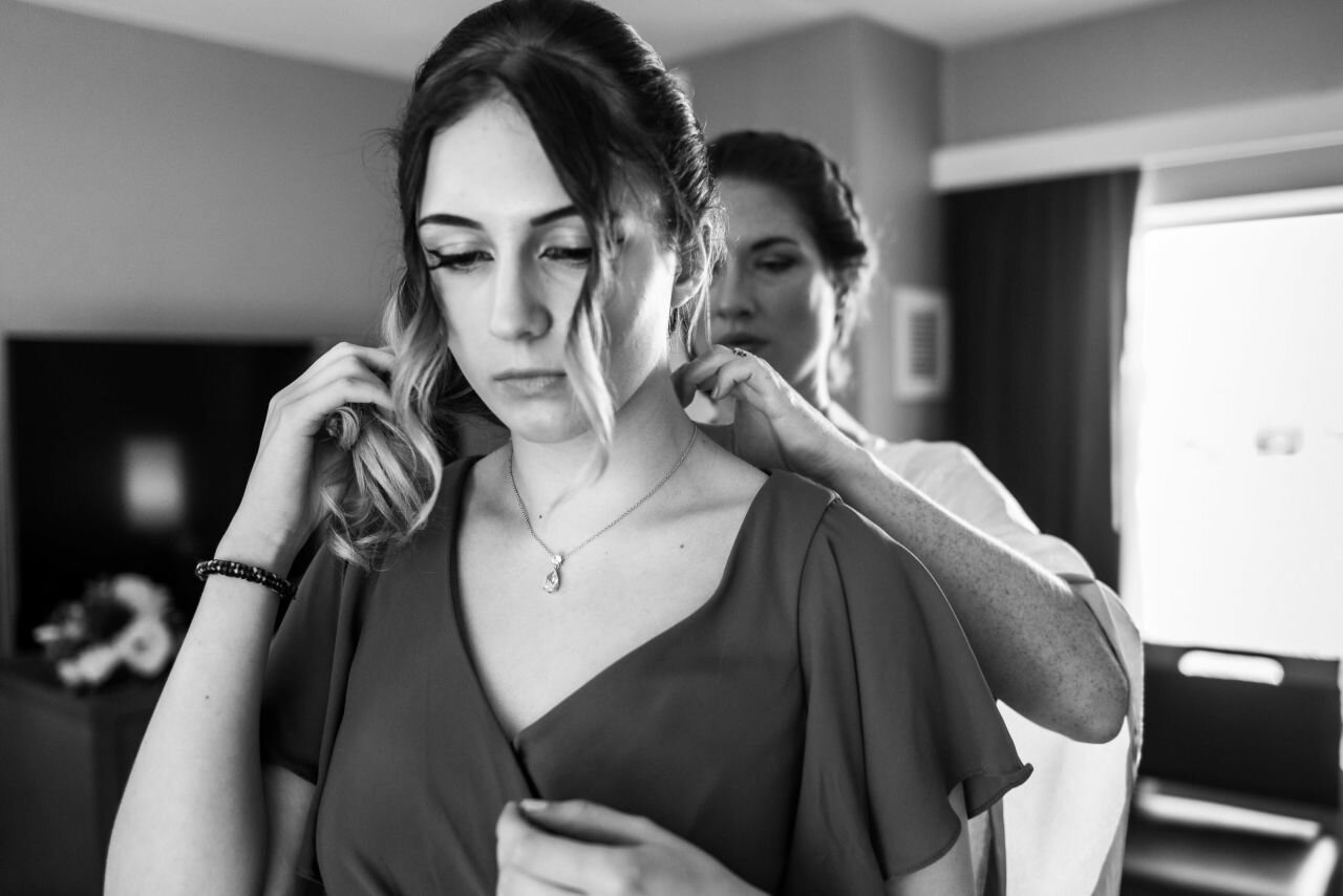 Bride helping her daughter get ready 