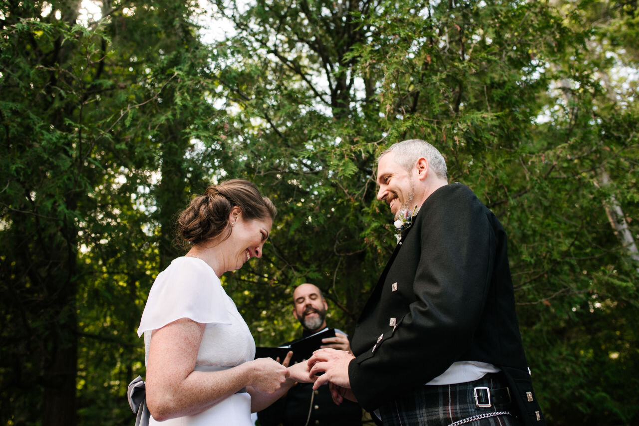 Bride and groom exchanging rings during their ceremony
