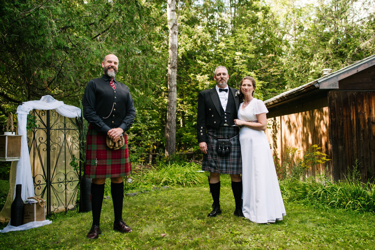 Bride and groom with their officiant at Ottawa wedding