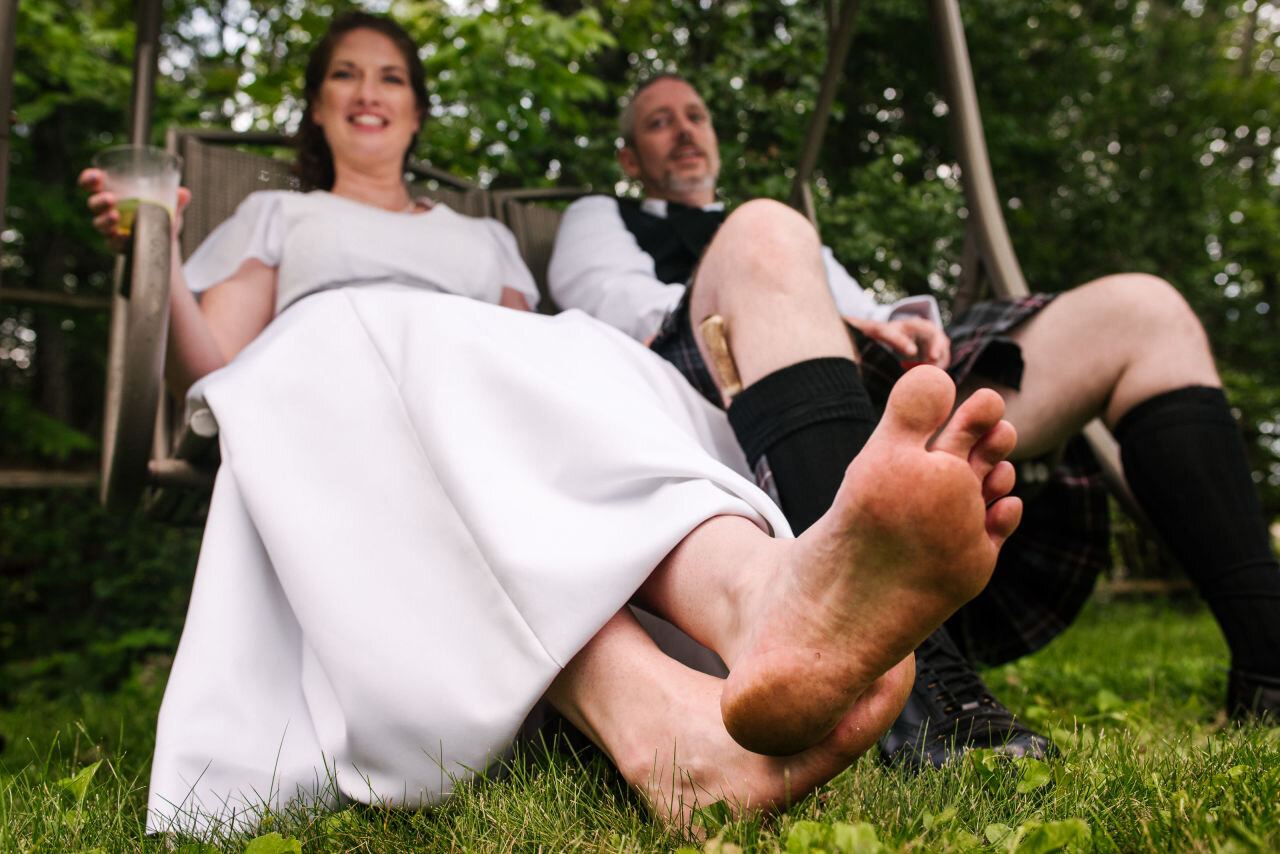 A barefoot bride and her new husband on a swing in Ottawa 