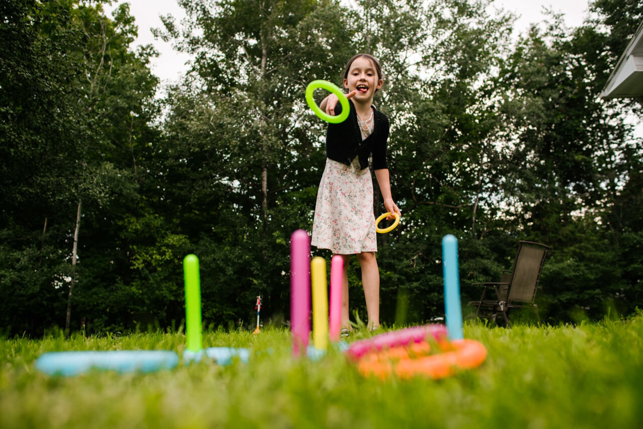 Young girl playing lawn games at Ottawa wedding 