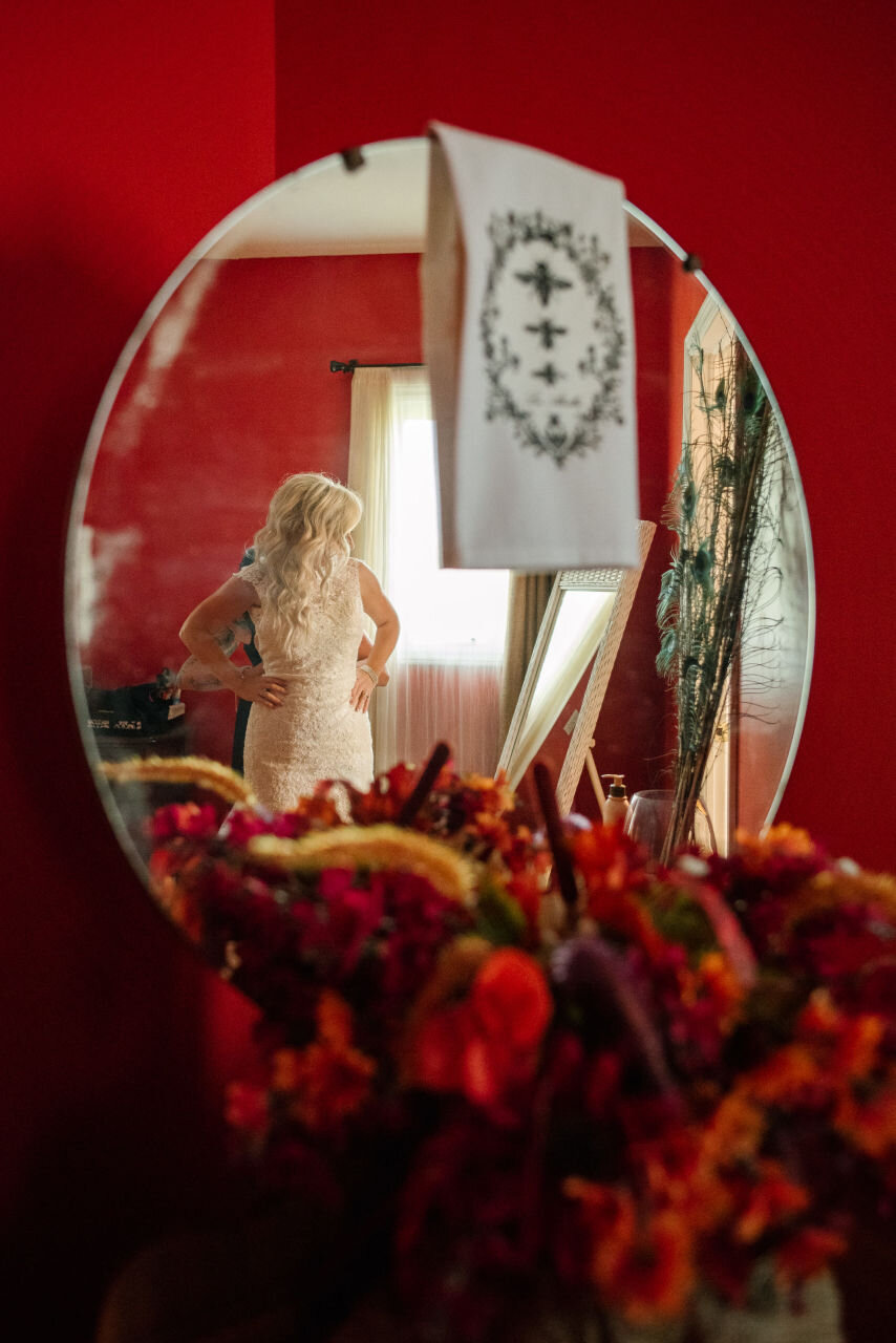 Bride reflected in her hotel room mirror before her Ontario elopement 