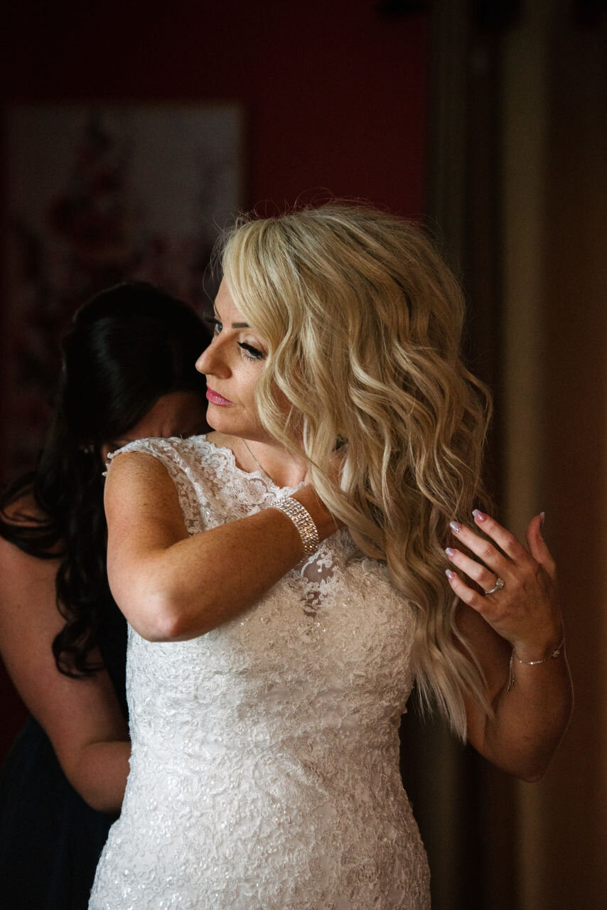Bride doing her hair before her Ontario rural elopement 