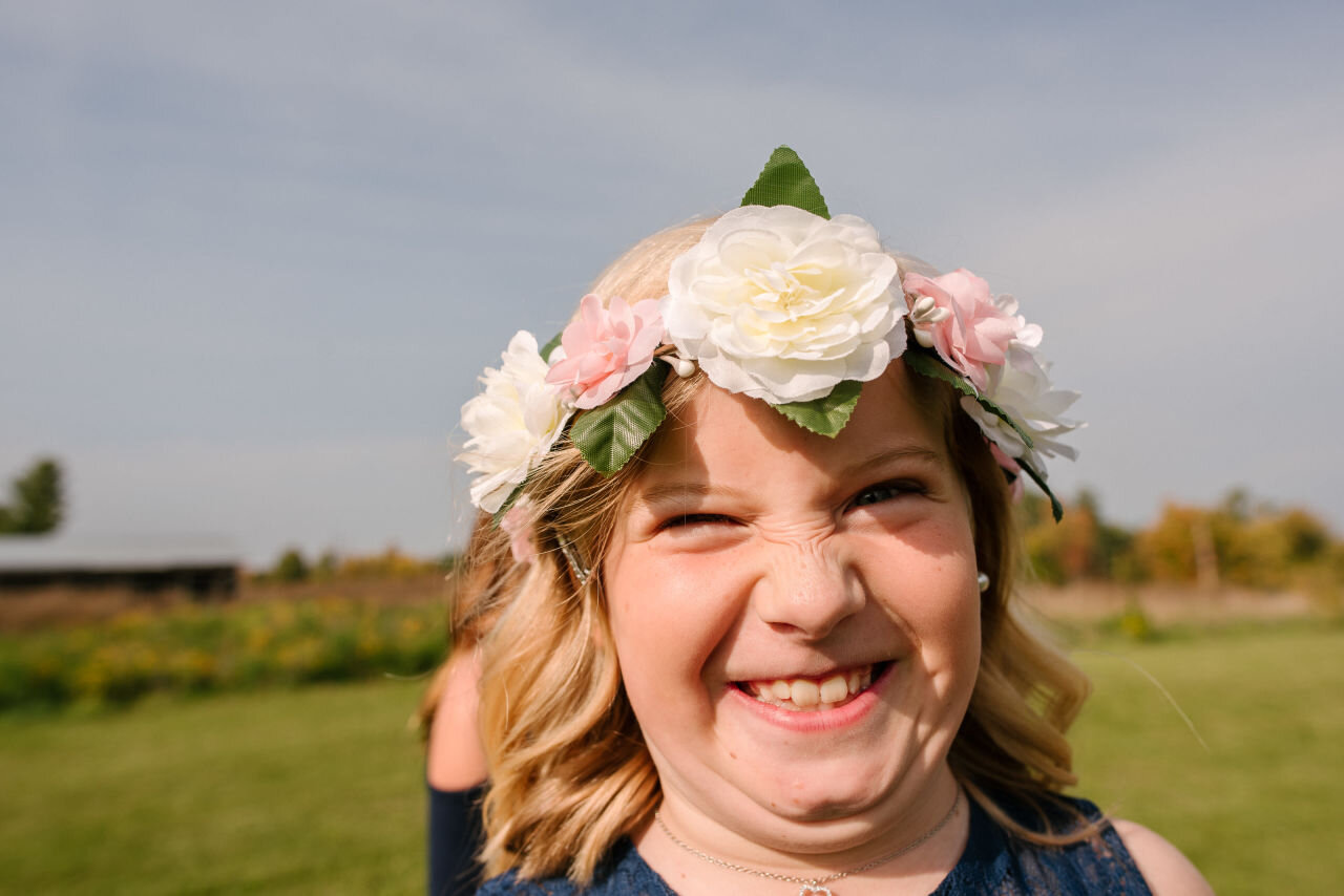 Flower girl pulling a funny face at rural Ontario elopement