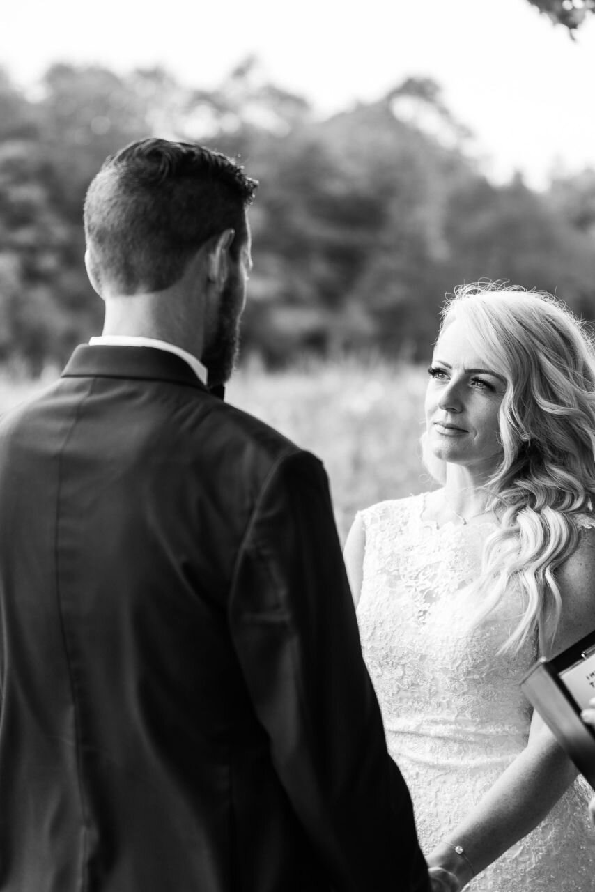 Bride and groom looking at each other during ceremony at rural Ontario elopement 
