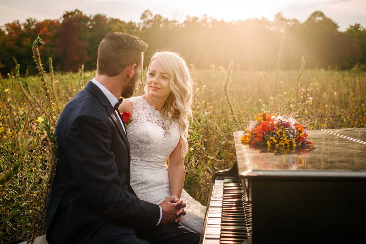 Bride and groom sitting together at sunset at rural Ontario elopement 