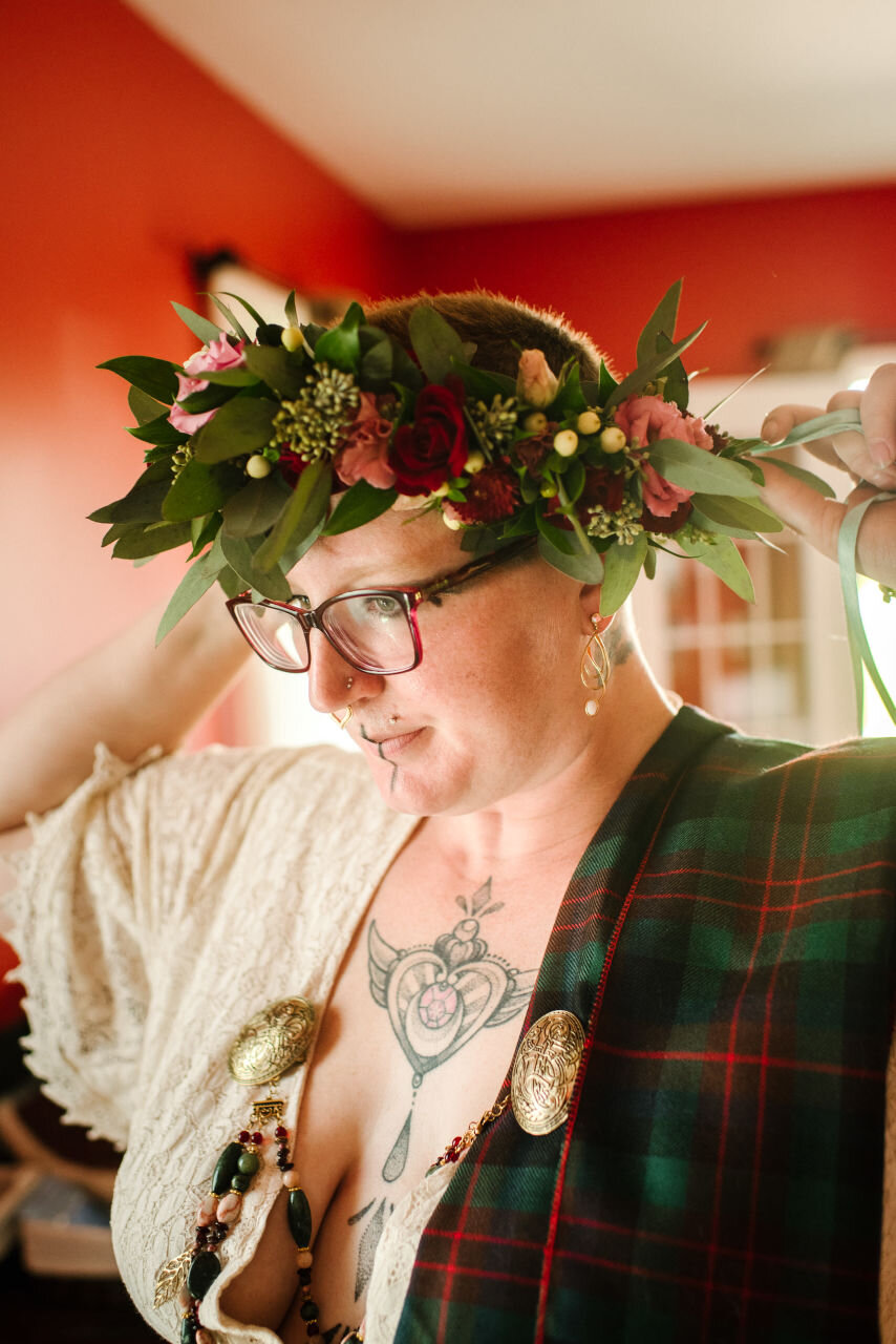 Bride wearing traditional flower crown and plaid fabric at rural elopement near Kingston, Ontario