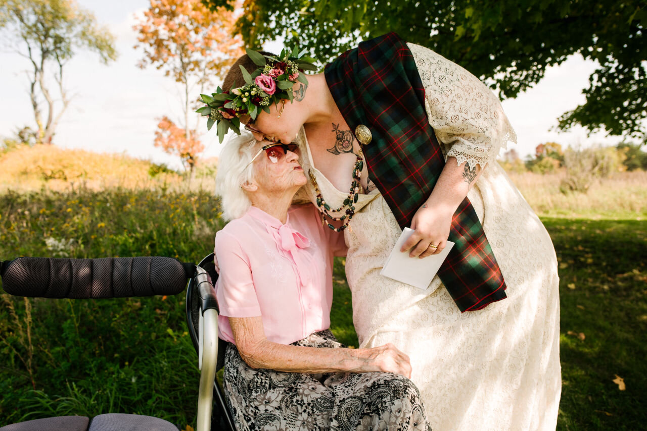 Bride kissing grandmother at rural elopement near Kingston, Ontario