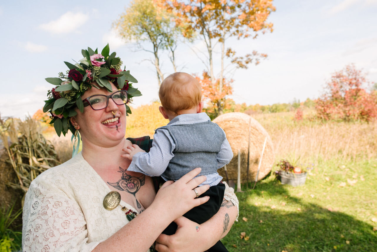 Bride with baby at her rural elopement near Kingston, Ontario