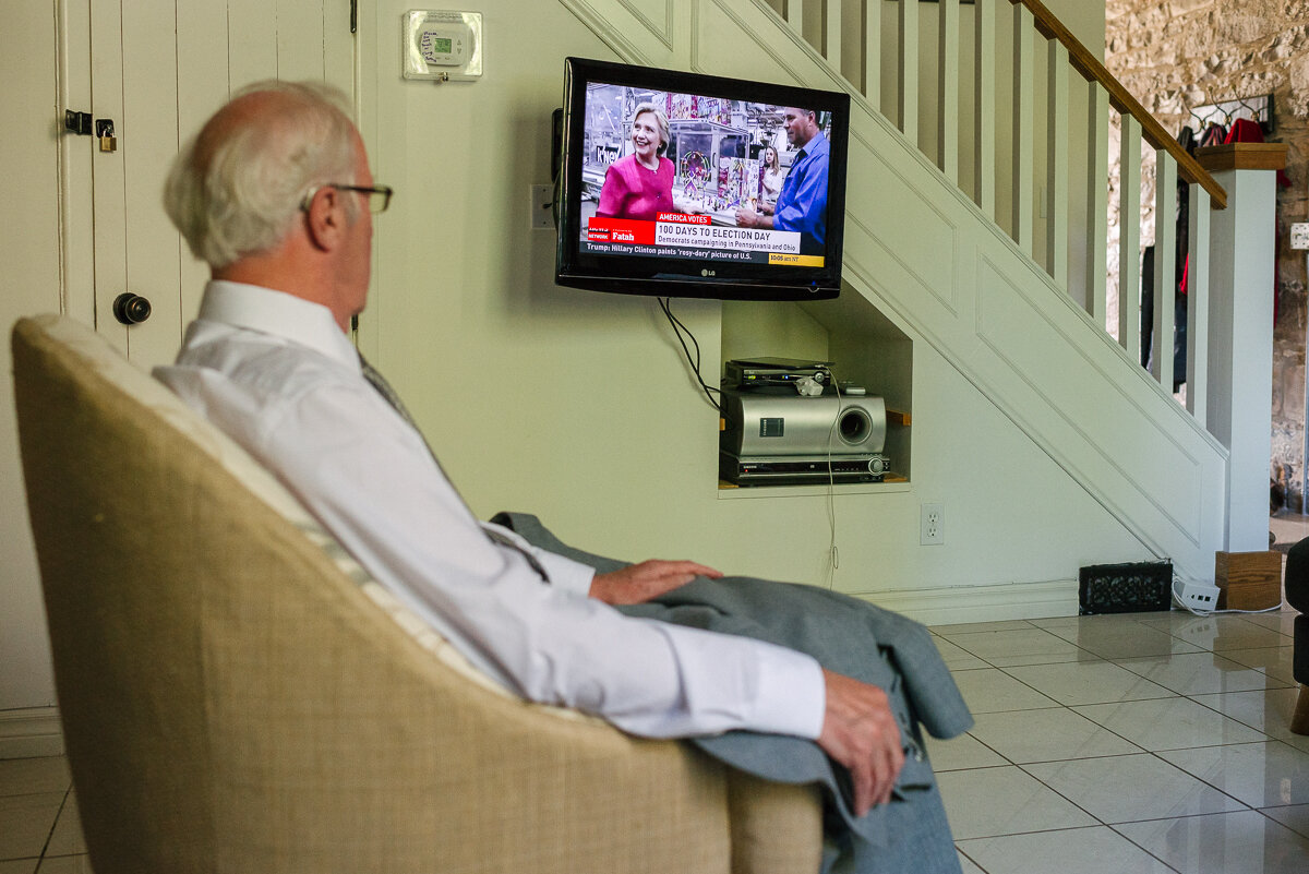 Man watching tv the morning of a family wedding