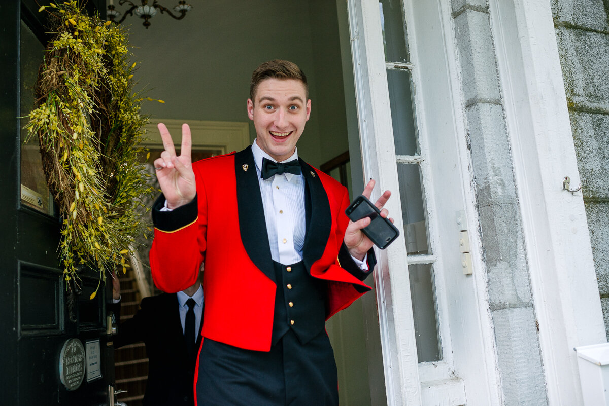 Groom giving the victory sign to the photographer