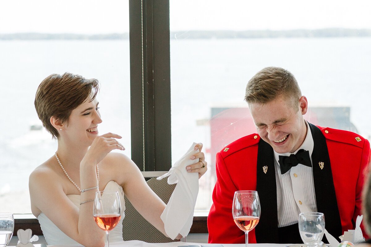 Bride and groom laughing during wedding reception