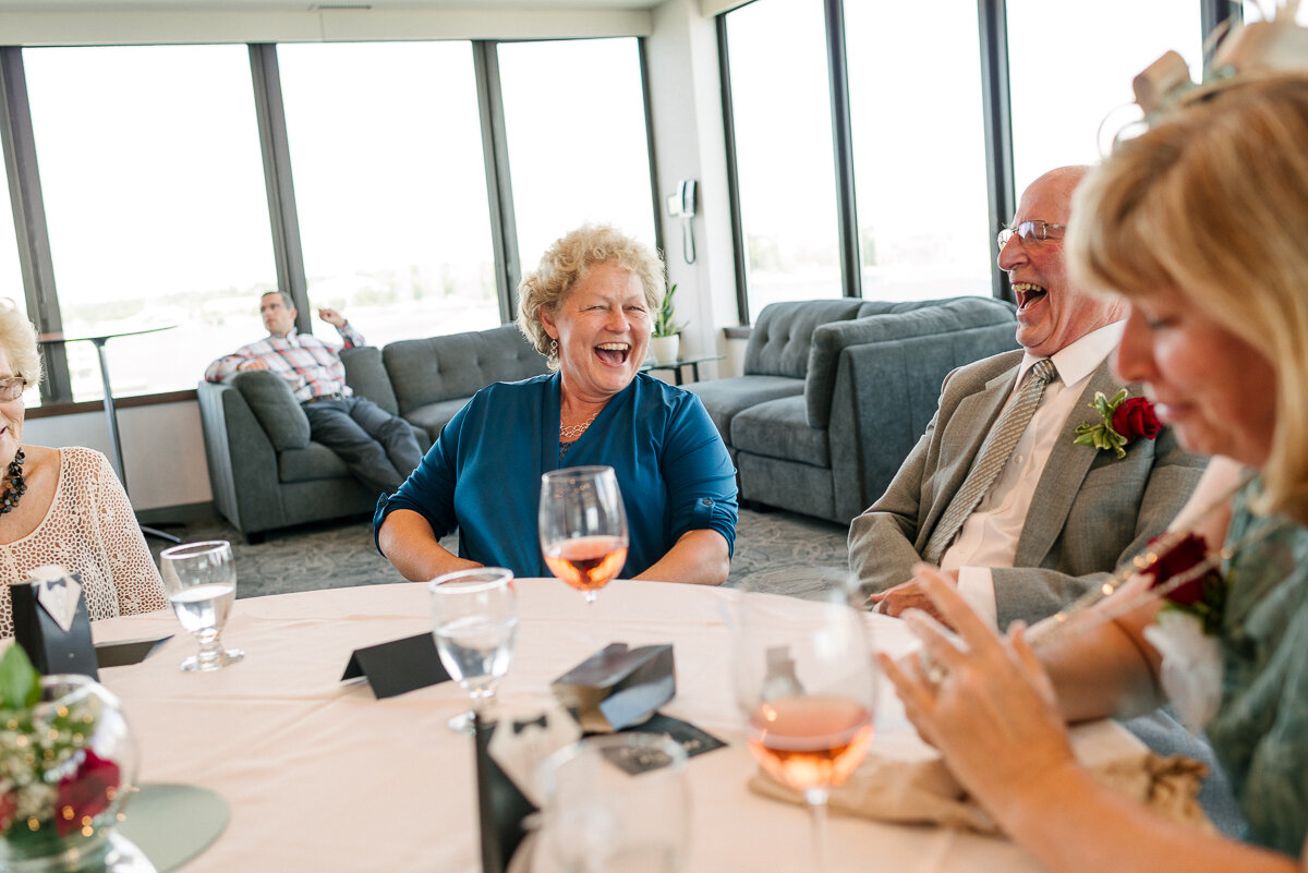 Guests laughing over drinks at Portsmouth Harbour wedding