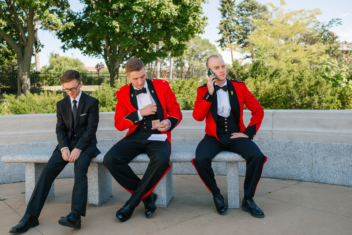 Grooms party made up of three men sitting on a bench