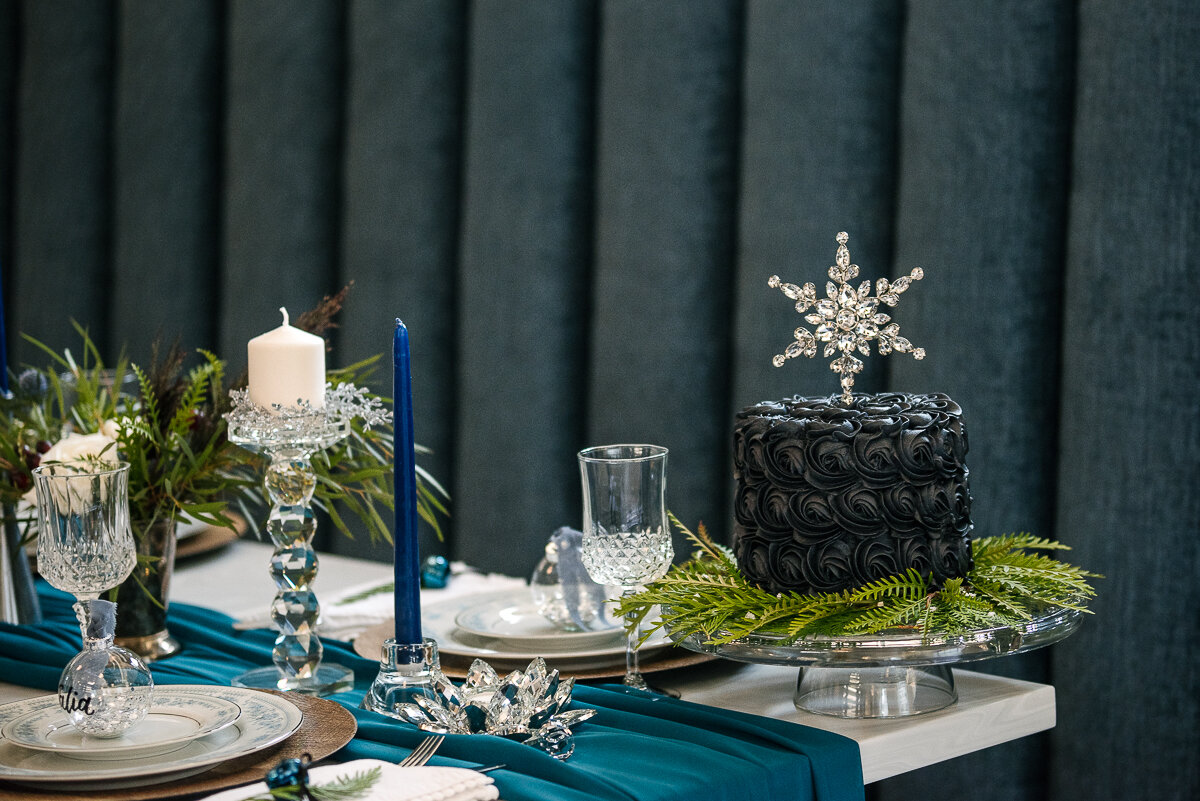 Winter wedding cake by Cake Cupboard, sitting on styled table 