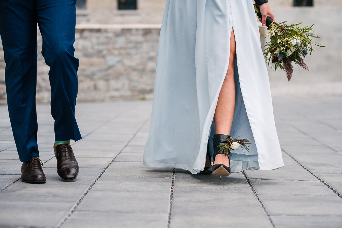 bride and groom walking, showing flower anklet and bridal bouquet 