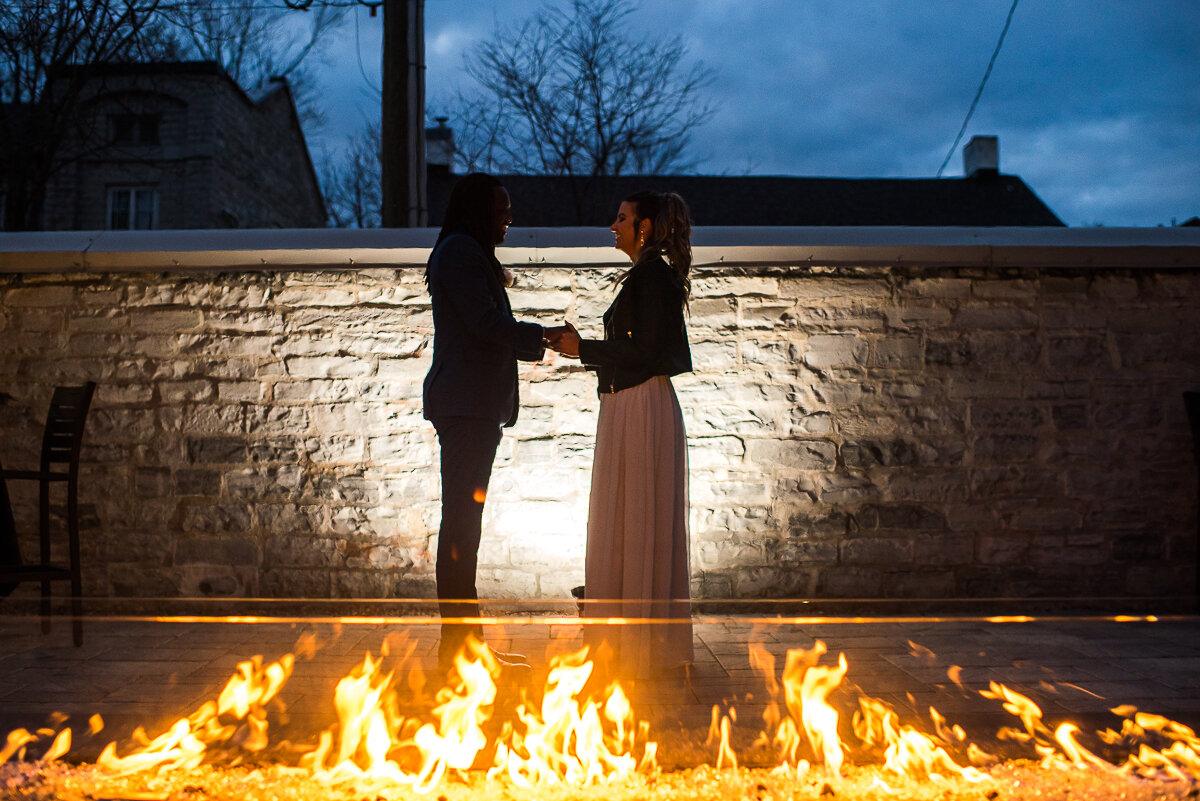 bride and groom enjoying the fire on the patio of the Frontenac Club 