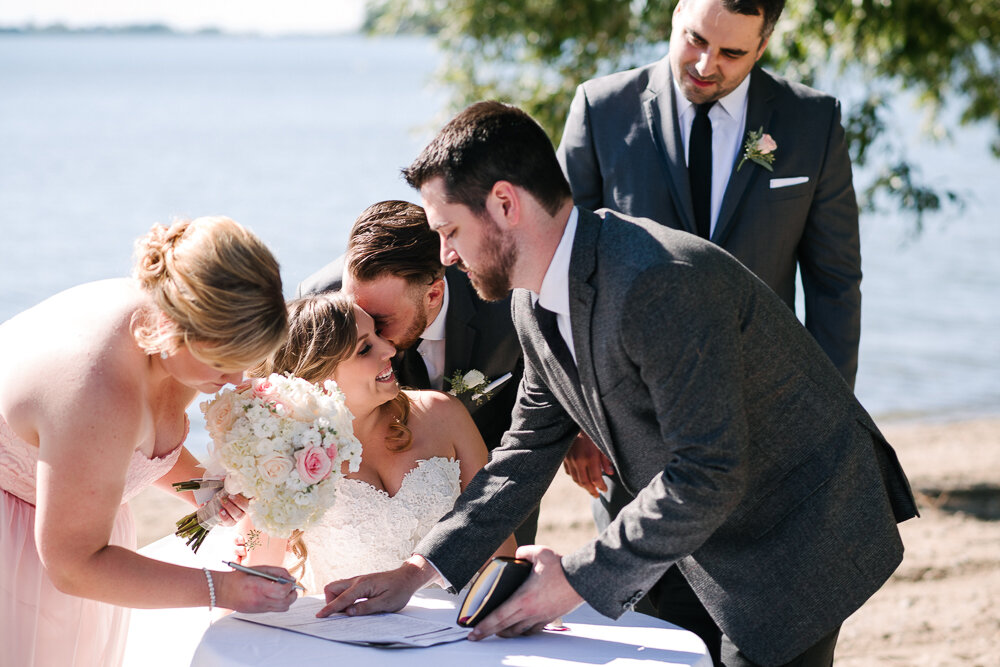witnesses signing the papers after wedding ceremony 