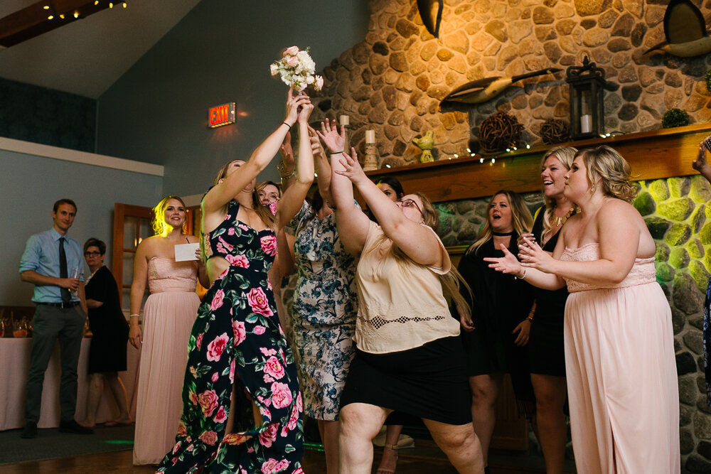 woman catches the bouquet at wedding reception at Isaiah Tubbs Resort