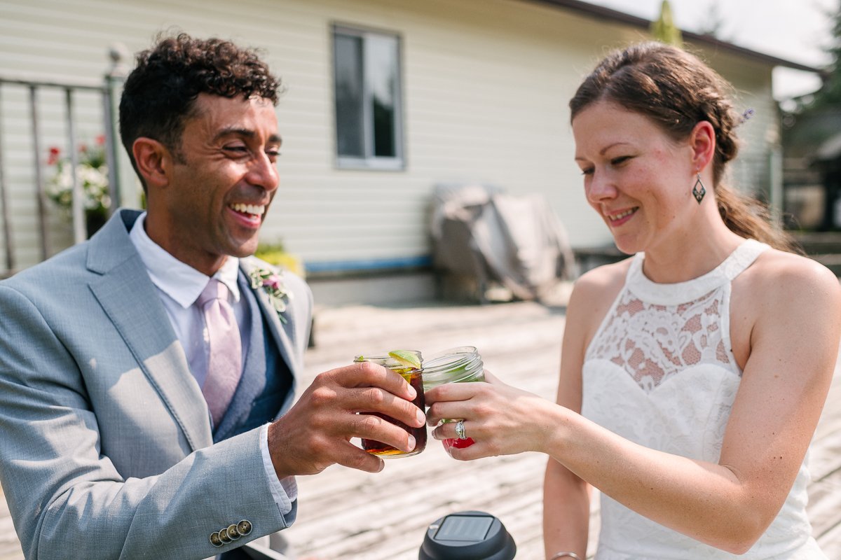 Bride and groom enjoying a cold drink on a summer day