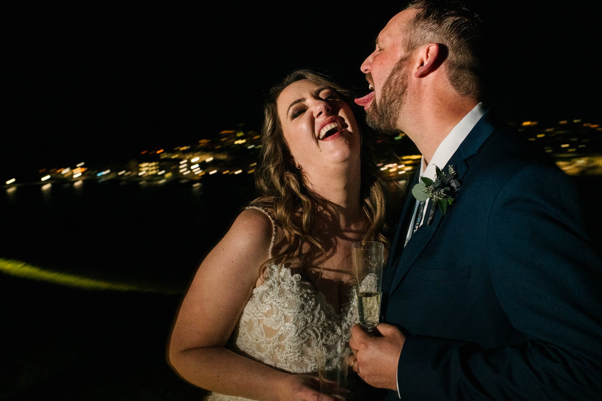 Groom licking her wife's face for a funny picture