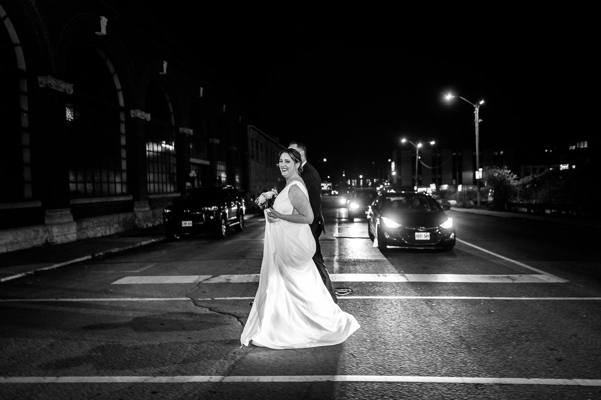 Black and white picture of bride walking on the street