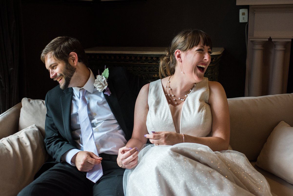 Bride and groom laughing with happiness on their big day