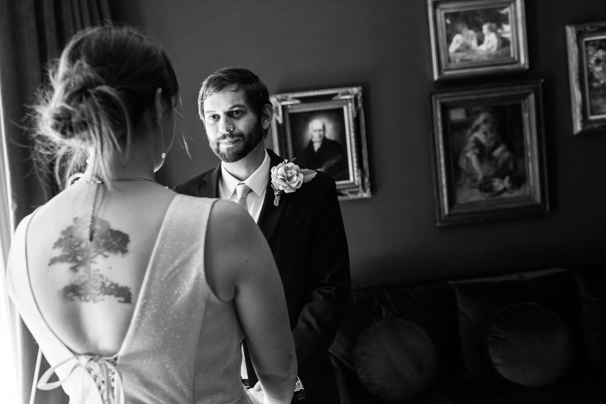 Black and white image of bride and groom looking into each other eyes.