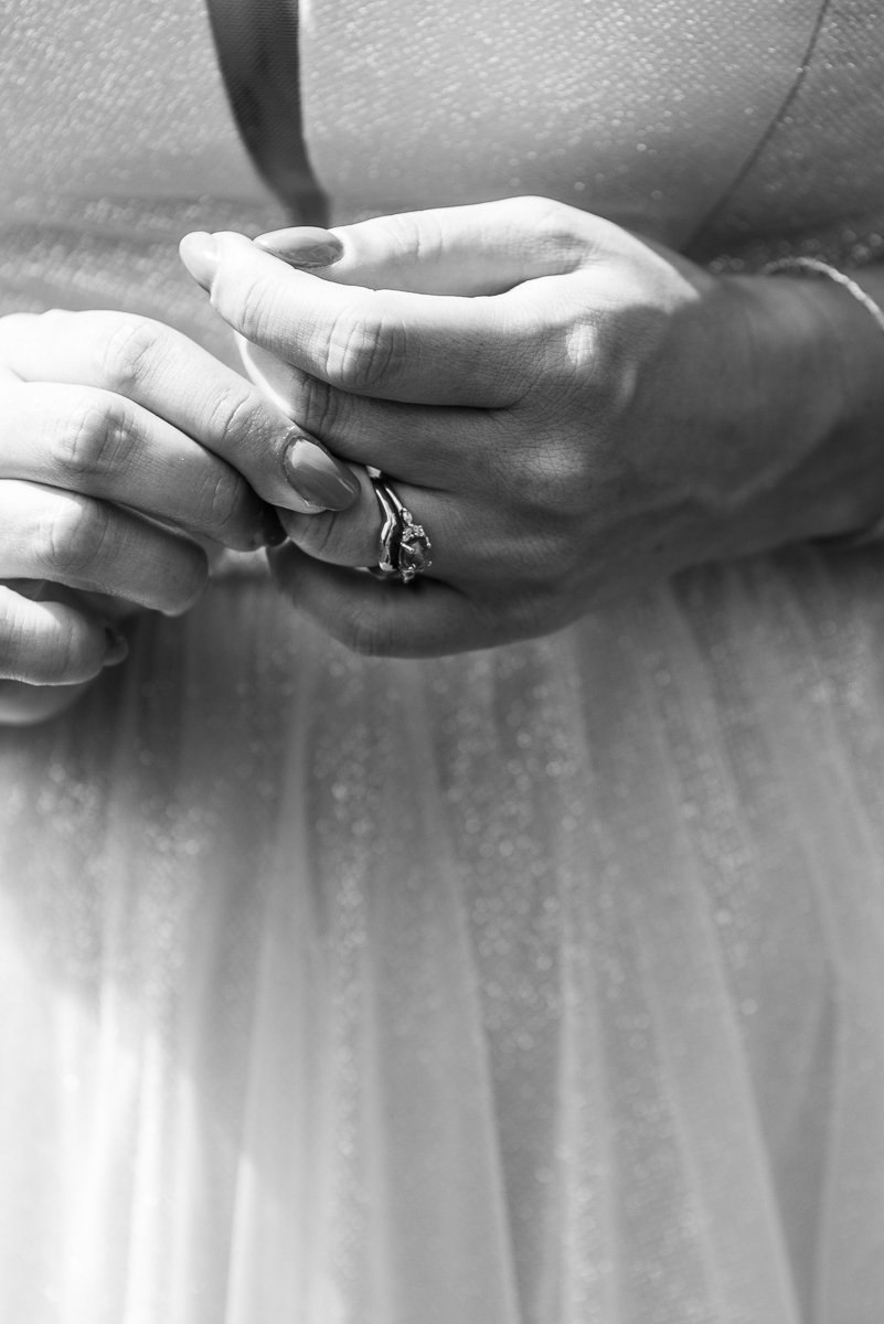 Bride wearing her engagement ring, picture focusing on fingers