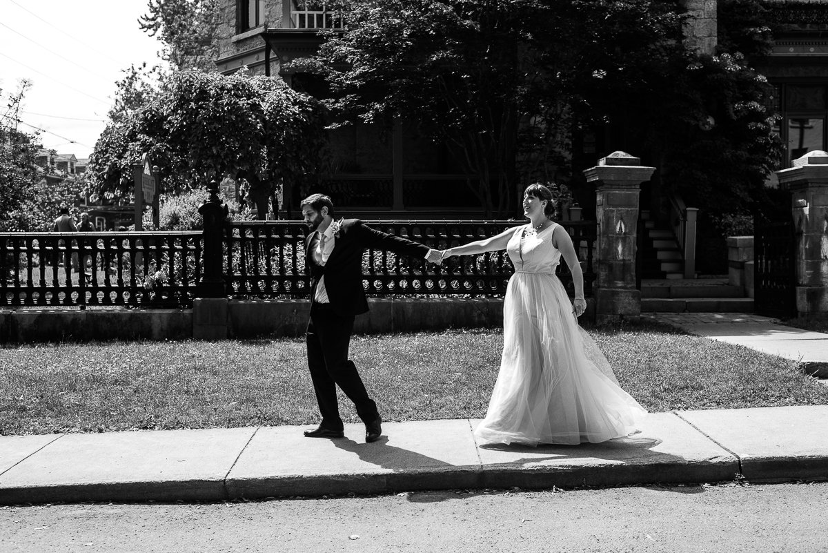 Black and white image of newly married couple walking together
